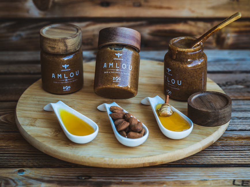 Amlou jars and almonds on a wooden tray, showcasing Moroccan flavors.